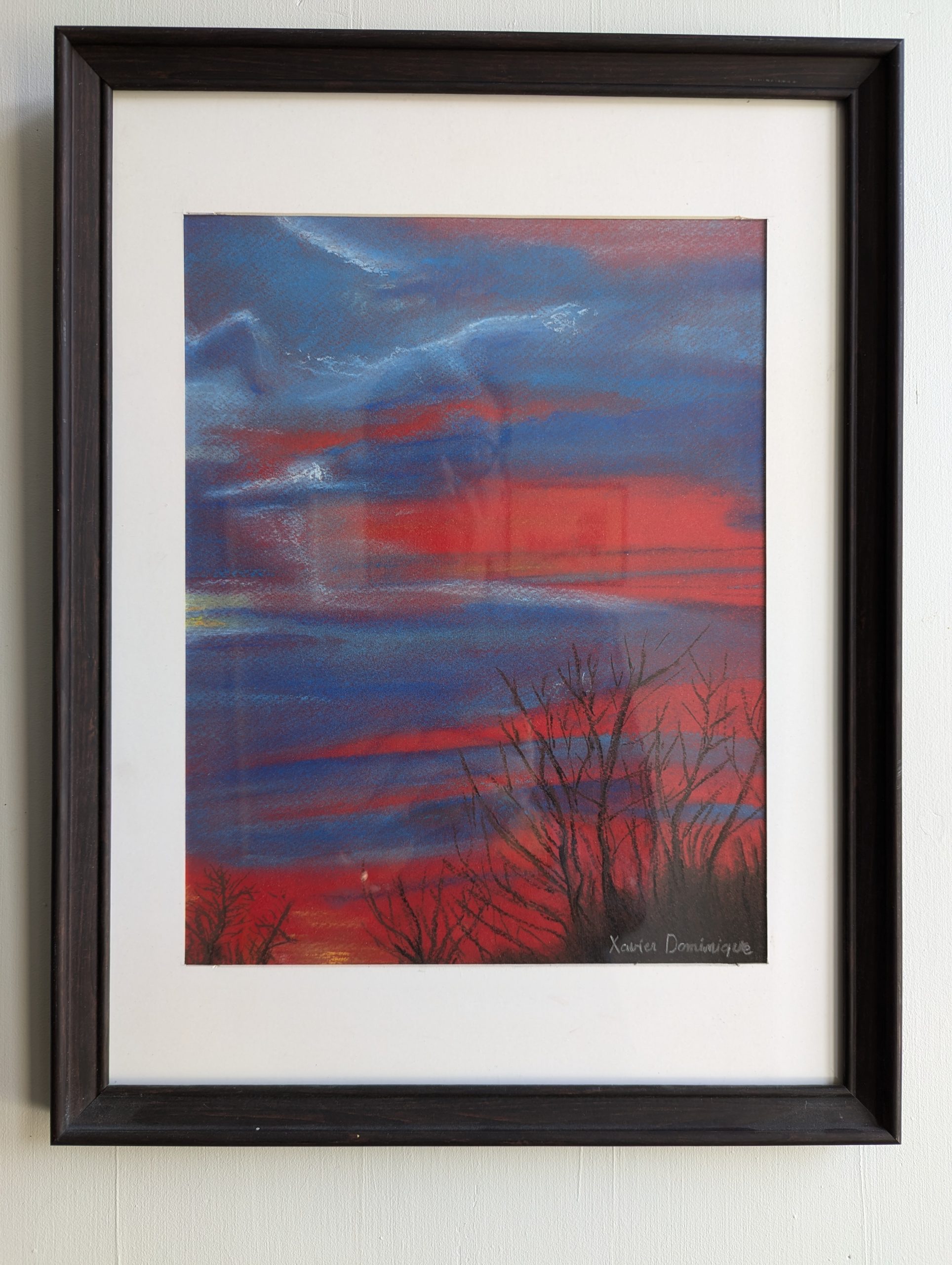 Dessin encadré du dessin réalisé au pastel d'un levé de soleil dans le Perche .
